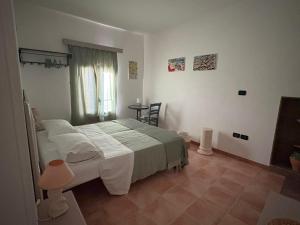 a bedroom with a large bed with white sheets at Dimora Lilium in Otranto