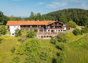 an aerial view of a large house on a hill at Neubichler Alm in Piding