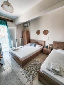 Postel nebo postele na pokoji v ubytování Aktaion Hotel