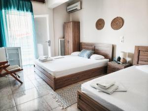 Postel nebo postele na pokoji v ubytování Aktaion Hotel