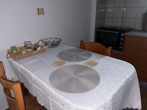 a table with a white table cloth on it at Chrisa's Apartments 1 in Missolonghi +13 photos