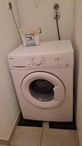 a white washing machine in a corner of a room at Dejan apartment4-Top centar in Pula