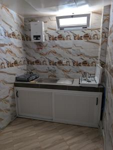 a kitchen with a sink and a counter top at Beach House - Tamraght, Aourir in Aourir