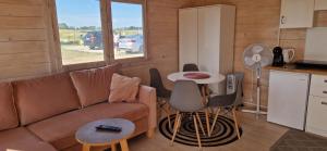 a living room with a couch and a table at Szary Domek Mikołajki in Mikołajki +24 photos