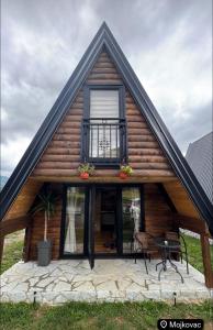 a log cabin with a window and a table at Tara lux in Mojkovac +18 photos