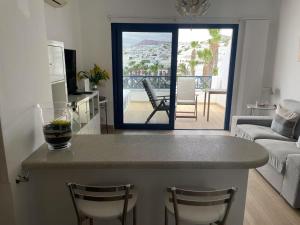 a kitchen and living room with a table and chairs at Sol Y Mar in Puerto del Carmen +25 photos
