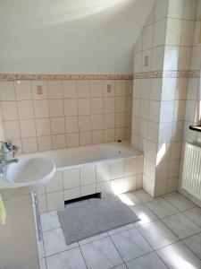 a bathroom with a tub and a sink at Przytulny kąt in Białowieża +33 photos