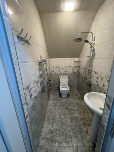 a bathroom with a toilet and a sink at Sheki GuestHouse in Sheki