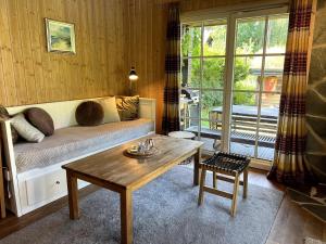 a living room with a bed and a table at Norwegian saunahouse in Haapse