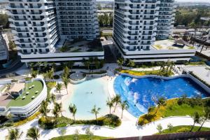 an aerial view of a pool in a resort with tall buildings at Azure North Monaco 10F Pool View with Netflix and WiFi and Karaoke in San Fernando