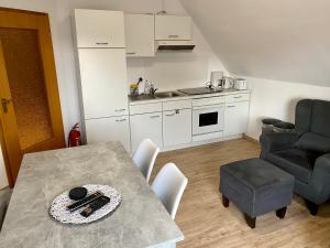 a kitchen and dining room with a table and chairs at Ferienwohnung Gisela in Ascheberg