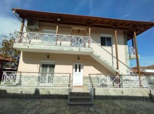 a house with a balcony and stairs on it at Krithia Apartment with Garden Family Apartment in Krithiá