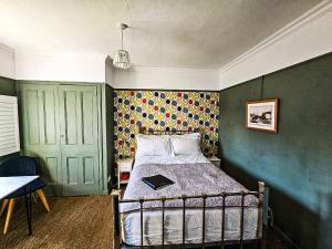 a bedroom with a bed with a book on it at The Lodge Stanwell in Stanwell