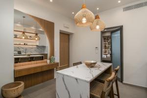 a kitchen with a marble counter and a island at Aqua Pearl Milos in Adamantas