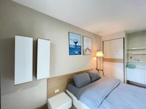 a small bedroom with a bed and two mirrors at Studio16 at Changwattana in Ban Bang Phang