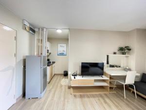 a living room with a refrigerator and a desk at Studio16 at Changwattana in Ban Bang Phang +19 photos
