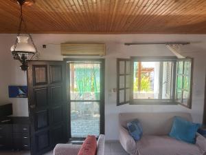 a living room with a couch and two windows at Erifyli in Nea Kallikrateia +20 photos
