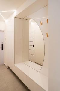 a dressing room with a mirror on the wall at Apartmoments Juzna Trieda in Vyšné Opátske