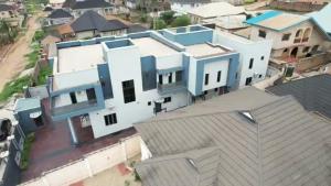 an overhead view of a large white house with blue accents at Lakeluxhomes Apartment in Ibadan