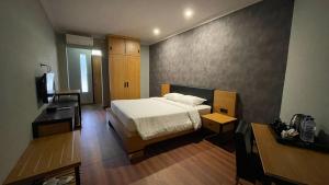 Postel nebo postele na pokoji v ubytování LPP Garden Hotel