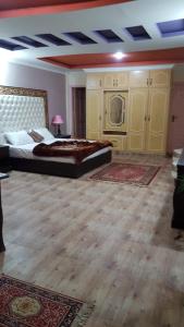 a large bedroom with two beds and a table at Executive Heights Apartments in Bhurban