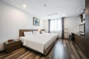 Postel nebo postele na pokoji v ubytování A25 Hotel - Hoàng Đạo Thúy 1