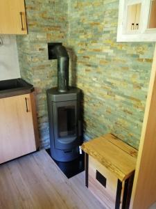 a stove in a room with a brick wall at Hiša pod Rogatcem - studio in Luče