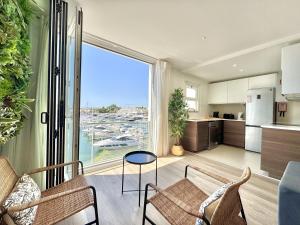a kitchen and living room with a large window at Vilamoura Marina View 4 by Homing in Vilamoura