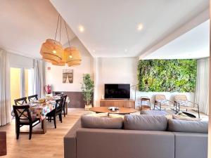 a living room with a couch and a table at Vilamoura Marina View 4 by Homing in Vilamoura