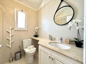 a bathroom with a sink and a mirror at Vilamoura Marina View 4 by Homing in Vilamoura +34 photos