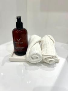 a bottle of soap and a pile of towels at Penthouse & Jacuzzi With Sea Views In Costa Blanca in Orihuela Costa +15 photos