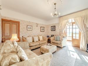 a living room with a couch and a table at The Old Farmhouse in Ancroft