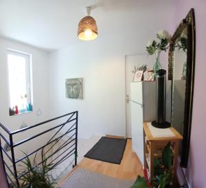 a room with a refrigerator and a mirror at Les Terrasses du Paradis in Orpierre