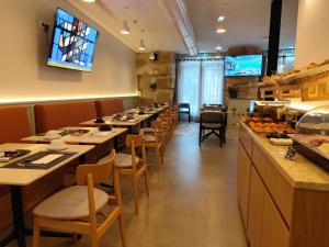 a row of tables and chairs in a restaurant at Bacalhoeiros 125 Hotel in Lisbon