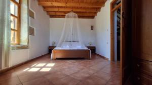 a bedroom with a bed with a mosquito net at Villa Nama in Kissamos
