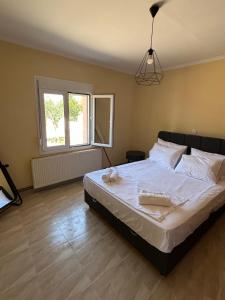 a bedroom with a large bed with white sheets at Phoenix Apartment in Xanthi