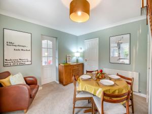 a living room with a table and a chair and a couch at Hill View in Pateley Bridge