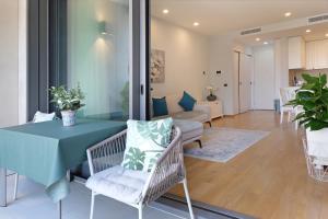 a living room with a table and chairs at New Luxury Dorcol Downtown Apartment in Belgrade