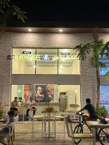 a restaurant with people sitting at tables in front of it at Aqua View Studio in Dawwār Abū Maḩrūs +26 photos
