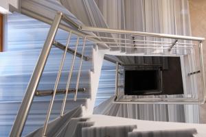 a metal staircase with a tv in a room at ORDAMS Villa in Himare
