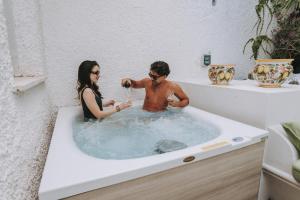 a man and a woman sitting in a bathtub at Villetta La Dolce Vista in Conca dei Marini +74 photos