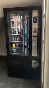 a black refrigerator with drinks inside of it at Kräuterhotel & Restaurant Heidejäger in Mulmshorn