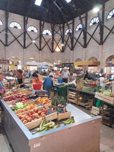 a group of people in a market with fruits and vegetables at Modern one bedroom cottage in Saint-Mandé-sur-Brédoire