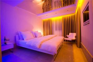 a bedroom with a white bed with purple lights at Venn Boutique Hotel in Samsun