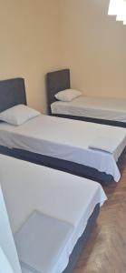 two beds sitting next to each other in a room at Uroš in Bački Petrovac