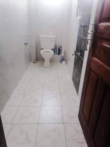 a bathroom with a toilet and a shower at HawiHomes in Mombasa