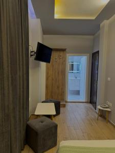 a living room with a couch and a table and a television at Vila Park Hotel 1 in Tirana +31 photos