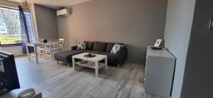 a living room with a couch and a table at Darena apart in Stara Zagora