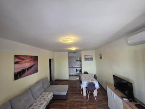 a living room with a couch and a table at Apartment Gligora in Mandre