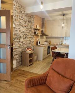 a kitchen and living room with a couch and a table at Zlatni dar in Žabljak